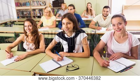 Young Smiling Students Studying In The Classroom