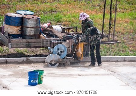 China, Heihe, July 2019: Workers Make The Laying Of The Embankment Road In Heihe City In The Summer