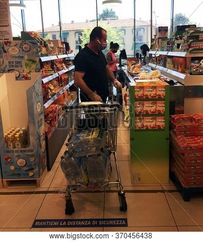 Bologna / Italy - June 6, 2020: Man At Supermarket Wearing A Medical Face Mask. Mantieni La Distanza