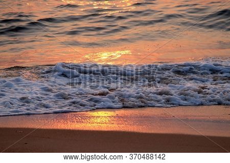 CANDOLIM, INDIA - FEBRUARY 18, 2020: Wave rolling over the sands on Candolim Beach, North Goa, India