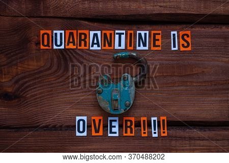 Lockdown Is Over Sign, Open Iron Lock On Wooden Background. Opening Borders Between Countries. End O