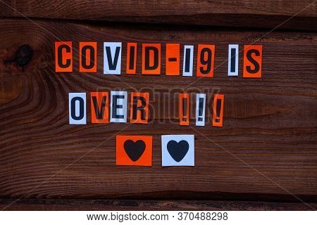 Covid-19 Is Over Paper Letters Sign On Wooden Background. Opening Borders Between Countries. End Of