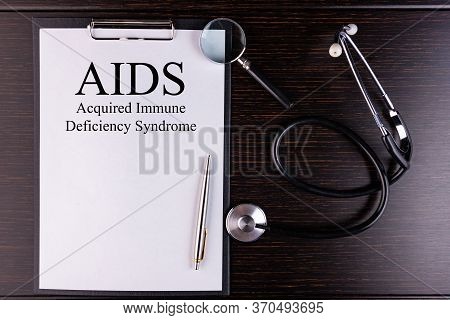 Page With Aids Acquired Immune Deficiency Syndrome On The Table With Stethoscope, Medical Concept