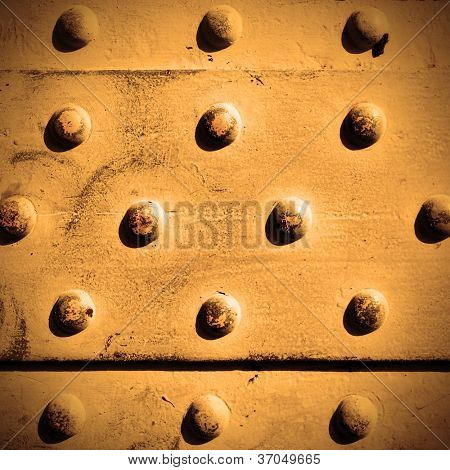ผิวโลหะด้วย rivets อาจใช้เป็นพื้นหลัง