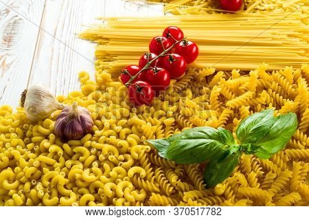 Curly Pasta And Basil Leaf On The Table