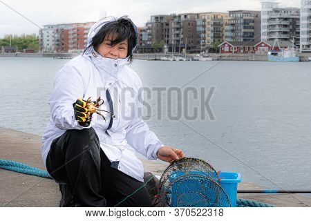 A Newly Catched Crab Showed By An Asian Happy Woman