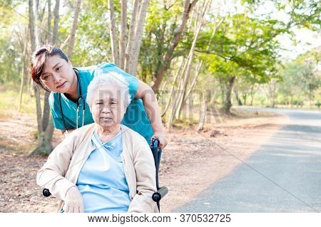 Doctor Help And Care Asian Senior Or Elderly Old Lady Woman Patient Sitting On Wheelchair At Park In