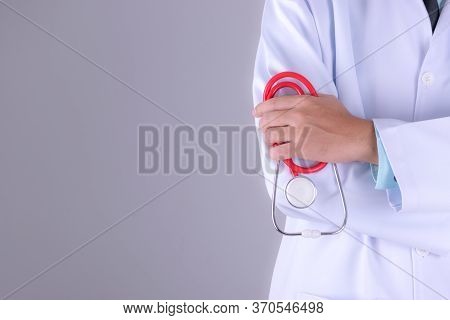 Medical Doctor Or Physician In White Gown Uniform With Stethoscope In Hospital Over White Wall Backg
