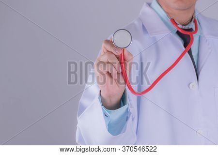 Medical Doctor Or Physician In White Gown Uniform With Stethoscope In Hospital Over White Wall Backg