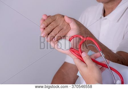 Geriatric Doctor Or Geriatrician Concept. Doctor Physician Hand On To Elderly Senior Patient To Comf
