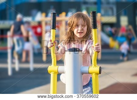 Cute Little Girl Sports On The Playground