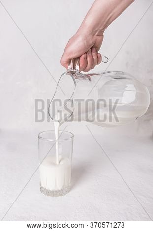 Kefir, Milk Or Ayran. Hand Holding A Jug. Light Background.