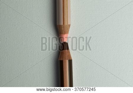 Two Pink And Brown Colored Pencils Facing Each Other