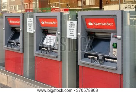 London, United Kingdom - April 09, 2020: Three Santander Bank Atm Withdrawal Terminals With Middle O