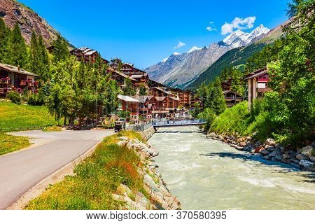 Traditional Local Houses Near The Matter Vispa River In The Centre Of Zermatt Town In The Valais Can