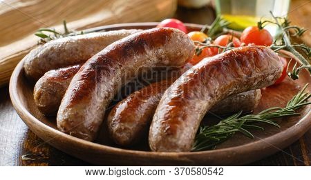 plate of german bratwurst sausages with herbs