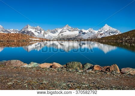 Riffelsee Lake And Matterhorn Mountain In The Alps, Located Between Switzerland And Italy