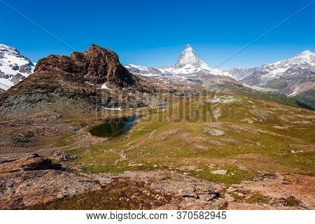 Riffelsee Lake And Matterhorn Mountain In The Alps, Located Between Switzerland And Italy