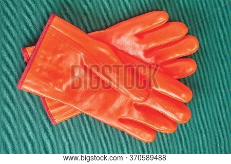 Orange Chemical Resistant Gloves With Protection From Cold, Industrial Protective Clothing, On A Gre