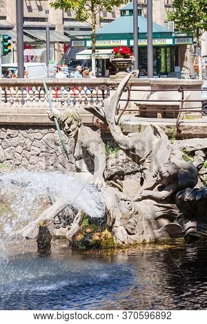 Dusseldorf, Germany - July 02, 2018: Triton Fountain Or Tritonenbrunnen Located At Konigsallee Or Ki