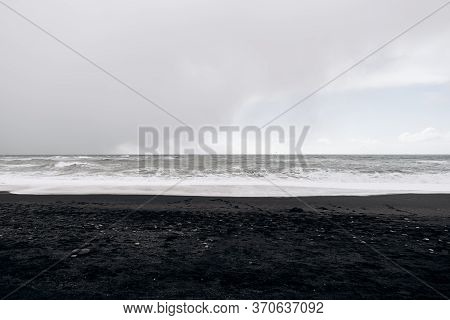 Cloudy Skies, Atlantic Ocean Waves And Black Sand On Vik Beach, Iceland.