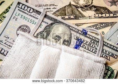 A Hundred-dollar Bill With A Medical Mask .the Concept Of Coronavrius Epidemic
