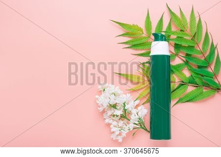 Cosmetic Bottle Green Color Containers With Green Herbal Leaves And White Flowers. Blank Label Packa