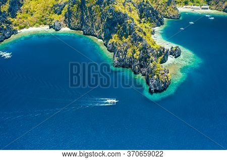 Aerial Drone View Of White Boat In Open Sea, Tropical Island And Beach Of Miniloc Island. El Nido, P