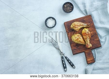 Grilled Chicken Legs On Plate On Grey Background. Top View.