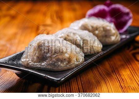 Closeup On Korean Patties Starchy Pyan-se Pygody On The Wooden Table, Horizontal