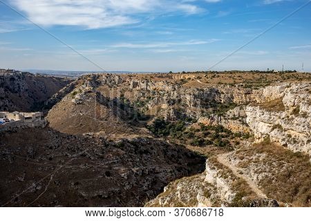 View Of Gravina River Canyon And Park Of The Rupestrian Churches Of Matera With Houses In Caves Di M