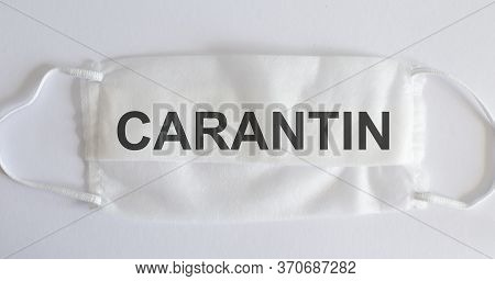 Medical Mask On A White Background With Text - Carantin. Virus Pandemic Protection Concept. Novel Co