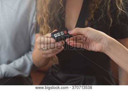 Concept Car Rental Service. Close Up View Hands Of Agent Giving Car Key To Client That Rent A Vehicl