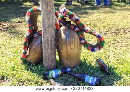 Bad Hindelang, Bavaria, Germany - September 10 2011: Huge Colorful Cowbell And Empty Beer Bootles On