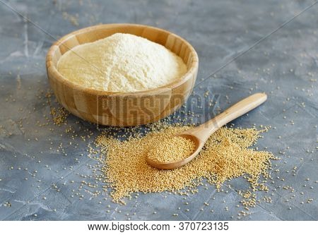Bowl Of Raw Amaranth Flour With A Spoon Of Amaranth Seeds Close Up