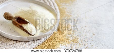 Plate Of Raw Amaranth Flour With A Spoon And Amaranth Seeds Close Up