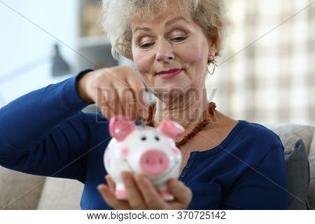 Portrait Of Senior Attractive Woman Holding Pink Piggy-bank. Elderly Female And Ceramic Container Fo
