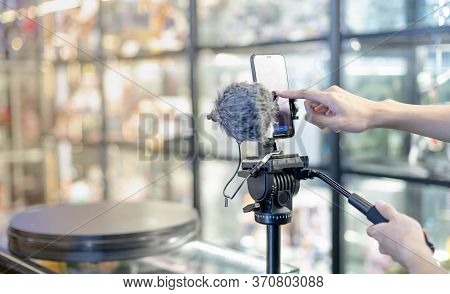 Male Hand Is Shooting A Video Using Gimbal And Smart Phone On Tripod For Live About The Product For 
