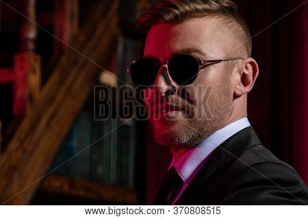 A close-up portrait of a brutal handsome businessman in sunglasses. Men's beauty, fashion. Optics for men.