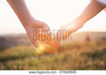 Lesbians Hold Hands At Sunset. Lgbt Lesbian Couple Moments Happiness Concept