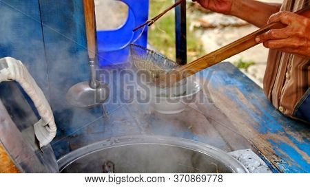 Indonesian Food, Mie Ayam, Noodles With Chicken Presented Directly By The Seller On The Cart, Unfocu