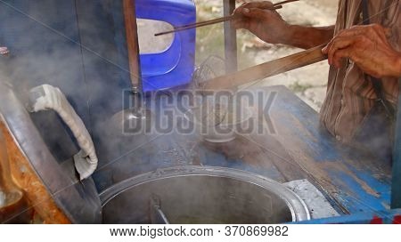 Indonesian Food, Mie Ayam, Noodles With Chicken Presented Directly By The Seller On The Cart, Unfocu