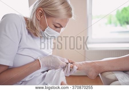 Professional Medical Pedicure Procedure Using Nail Clippers Instrument. Patient Visiting Chiropodist