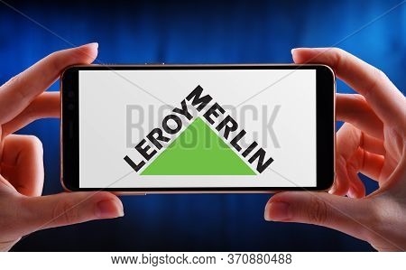 Poznan, Pol - May 21, 2020: Hands Holding Smartphone Displaying Logo Of Leroy Merlin, A Home Improve