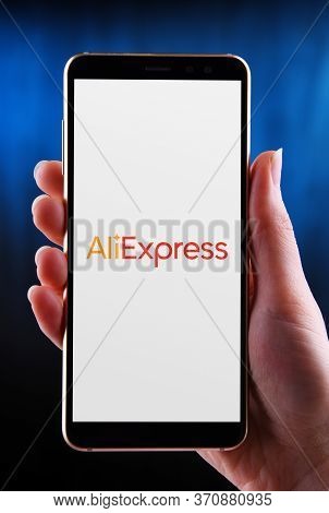 Hands Holding Smartphone Displaying Logo Of Aliexpress