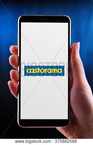 Poznan, Pol - May 21, 2020: Hands Holding Smartphone Displaying Logo Of Castorama, A French Retailer