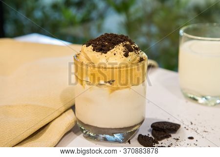Homemade Dalgona Whipped Coffee With Cookies Crump In A Cup On A White Table With A Cup Of Milk Blur