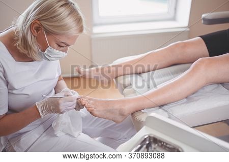 Professional Medical Pedicure Procedure Close Up Using Double Nail Instrument. Patient Visiting Chir