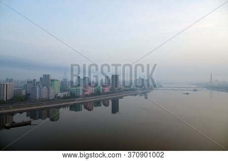 Pyongyang, North Korea. Skyline And Taedong River In The Morning Fog. View On Modern Residential Com