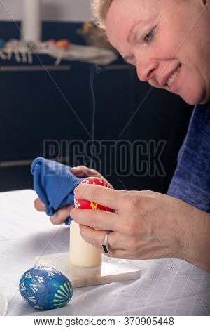 Sorbian Redhead Women\'s Hands Remove With A Candle Flame The Wax According To Sorbian Tradition Of 